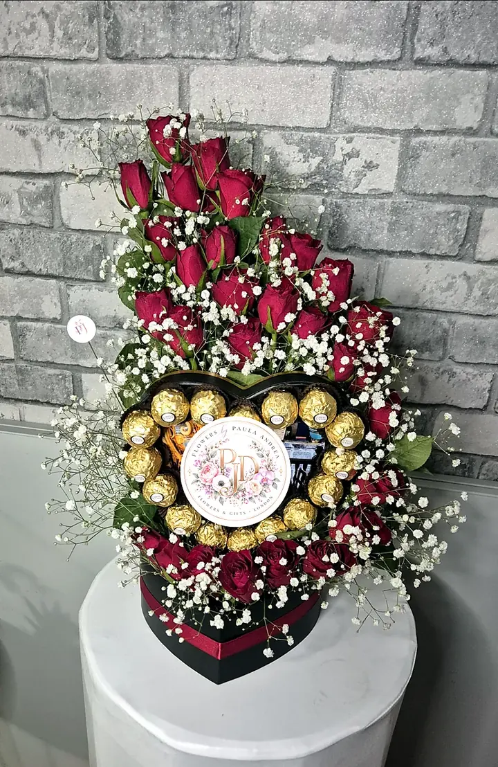 Heart-shaped gift box with red roses and Ferrero Rocher chocolates