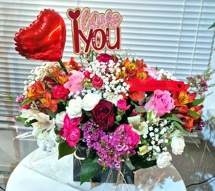 Flower bag with a red heart balloon, a Love You topper, roses and alstroemeria
