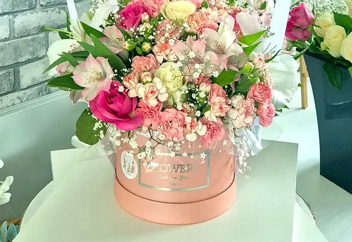 Pink flower hat box with roses, carnations and gypsophila