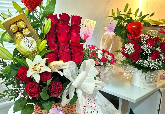 Basket of red roses and white lilies with a box of Ferrero Rocher